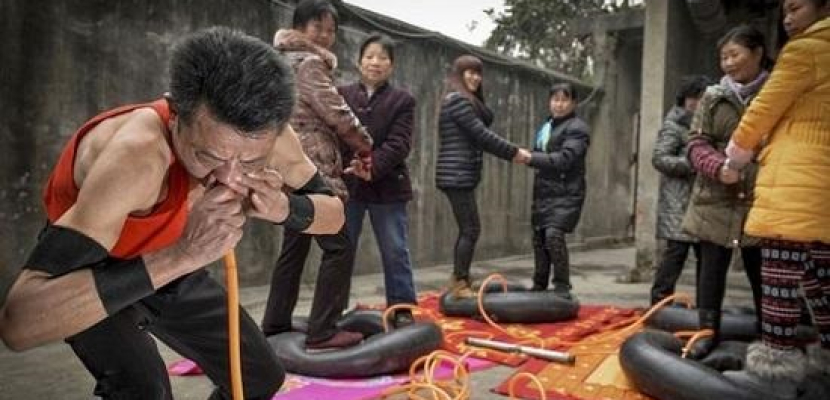 رجل صيني ينفخ 4 إطارات بأنفه في 21 دقيقة